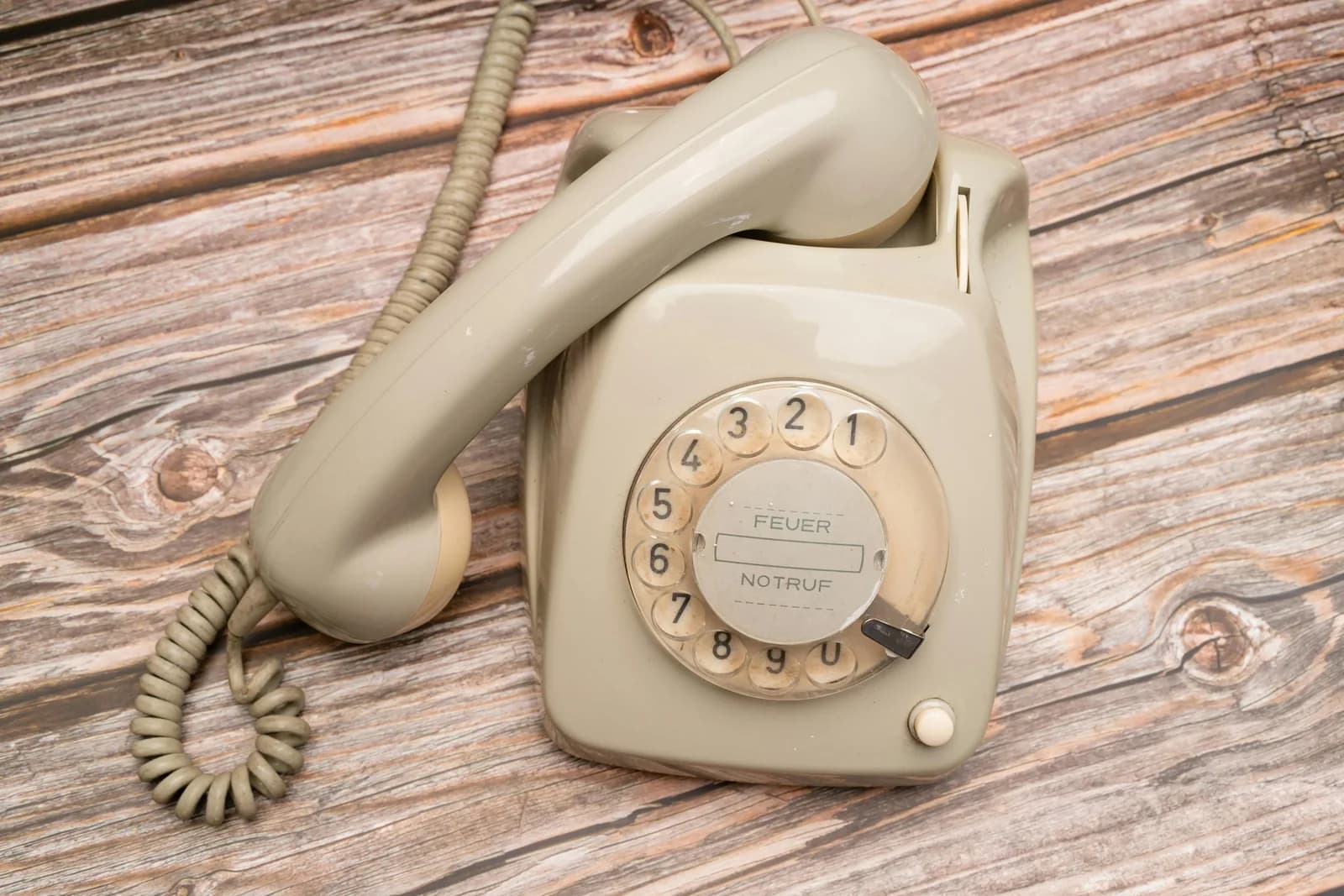 Close-up of a retro rotary telephone on a wooden surface