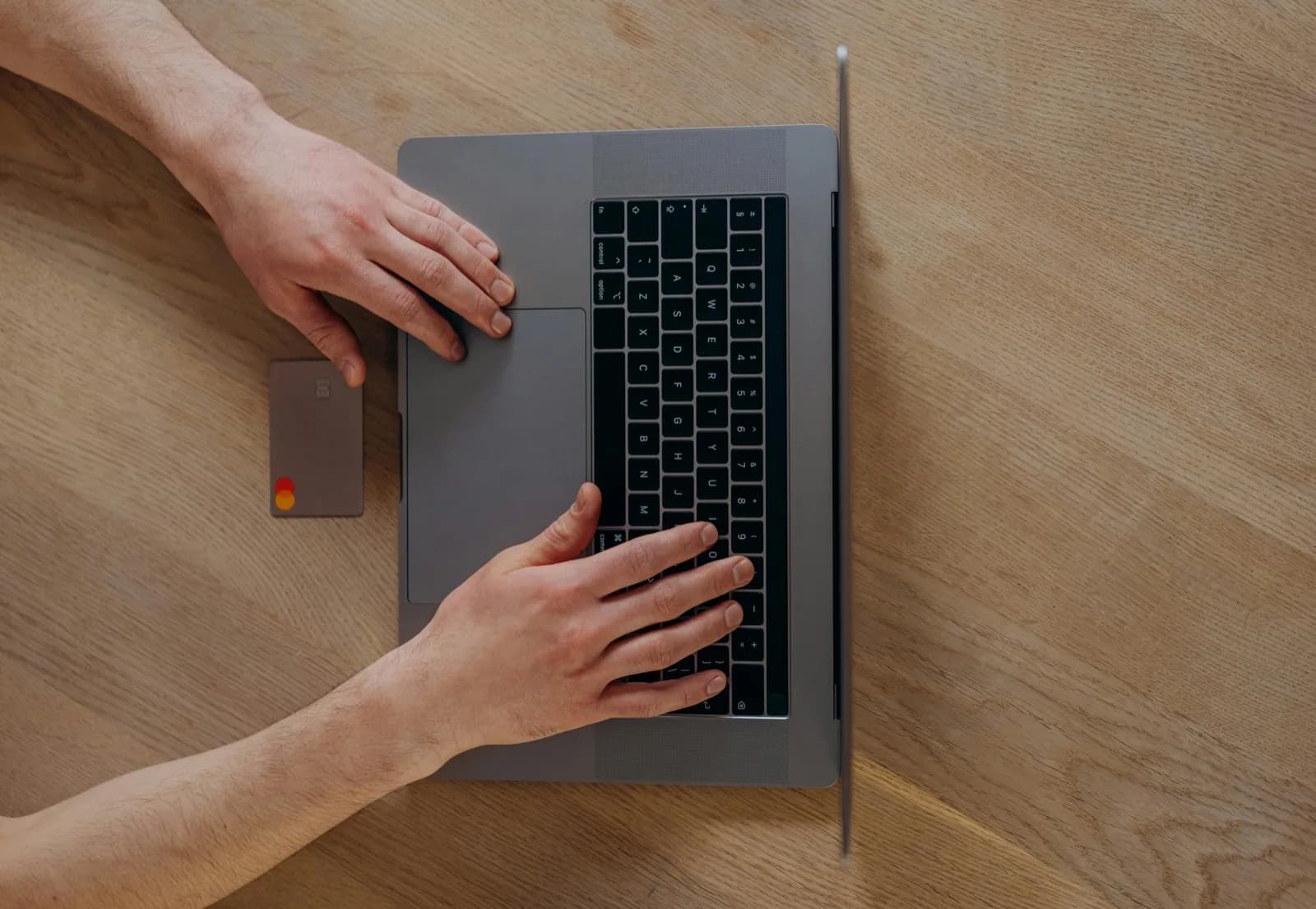 Traveler using a laptop in a public space, handling banking online