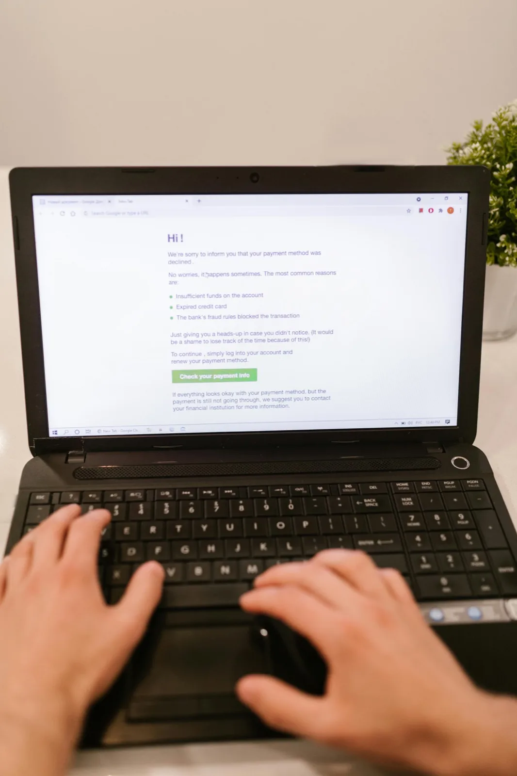 Person focused on a laptop in a clean workspace