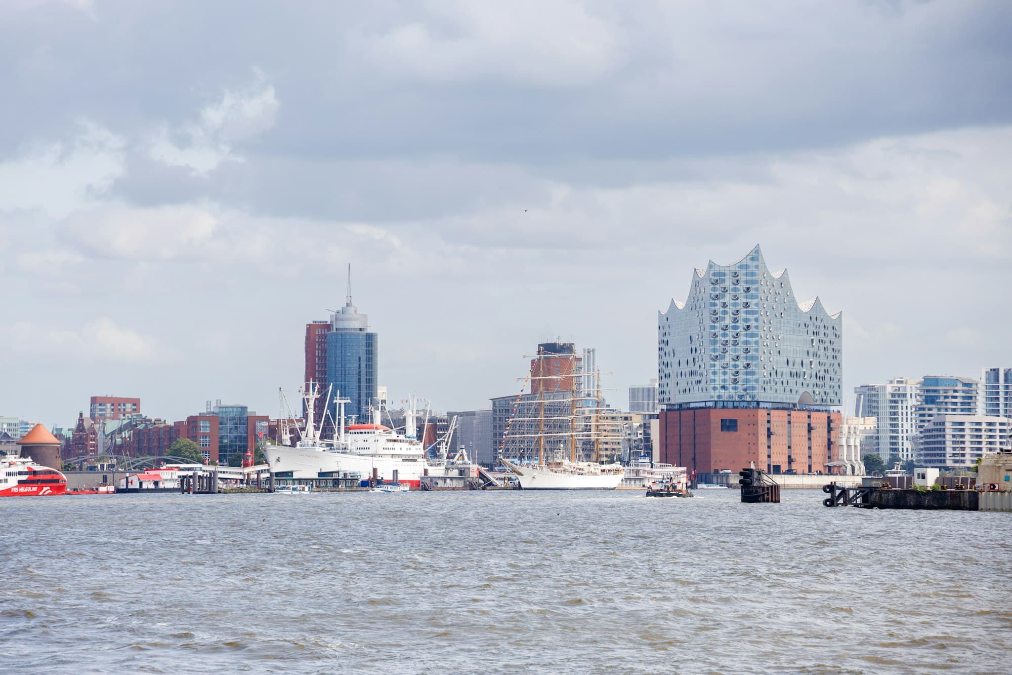 Modern high-rises cluster along a compact harbor skyline.