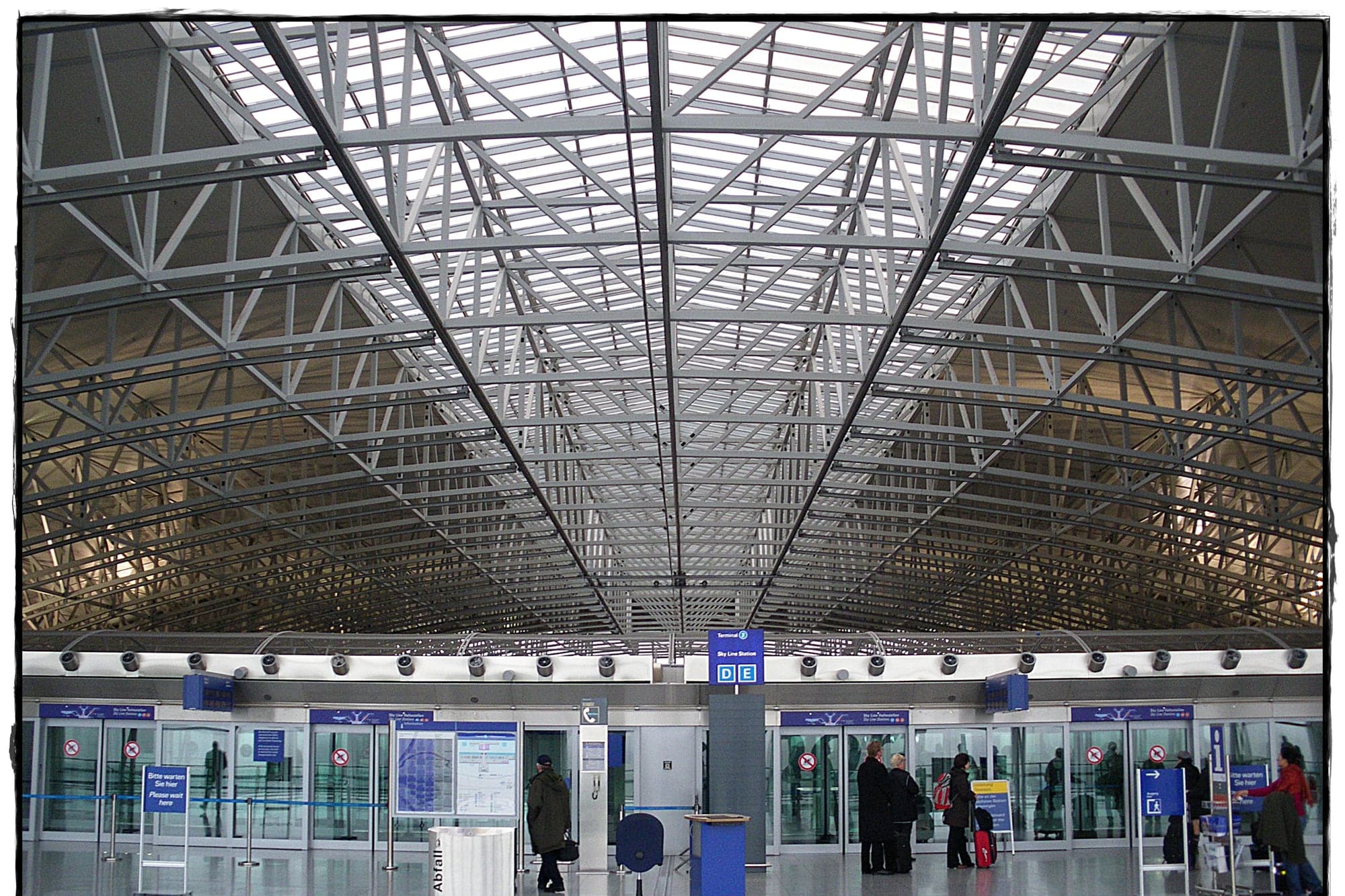Wide view across Frankfurt Airport Terminal 2 showing a busy international departures hall.