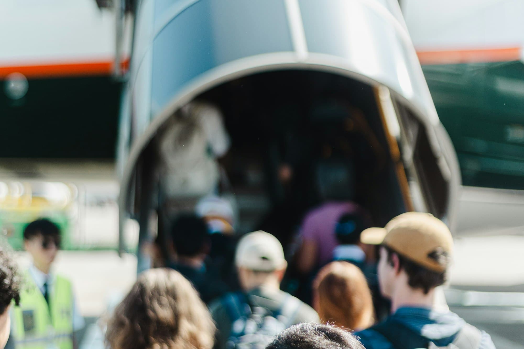 Passengers board an airplane through a jet bridge.