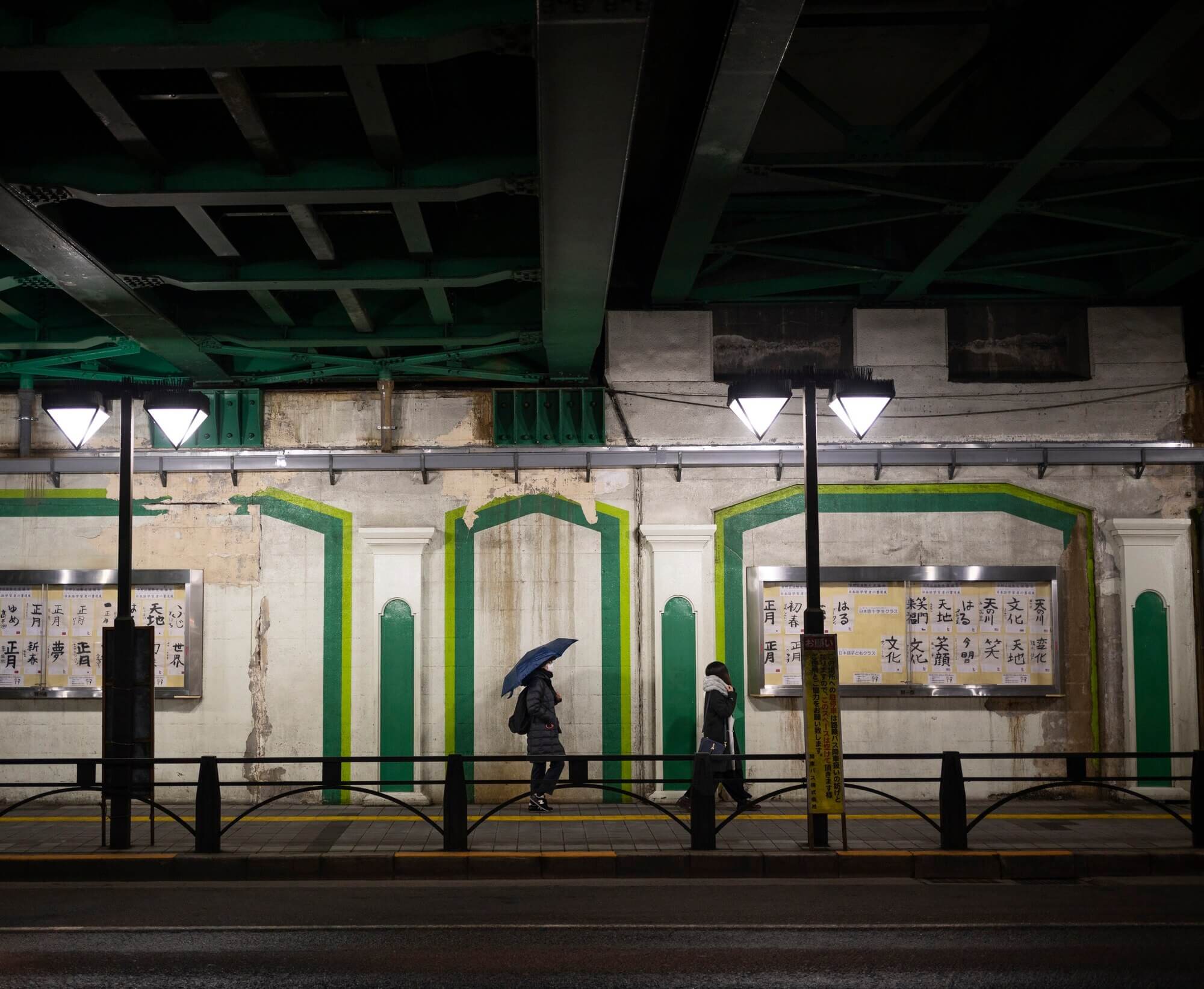 Tokyo's illuminated skyline at night, with rail lines and dense high-rise development in view.